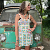 Someone wearing the beige Sleeveless Knit Tank Dress in front of an old teal Volkswagen bus.