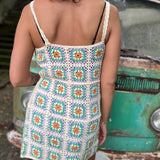 Someone wearing the beige Sleeveless Knit Tank Dress in front of an old teal Volkswagen bus.