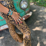 Someone wearing the Mustard Animal Print Bell Bottoms with Elastic Waist.