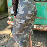A woman wearing the Camo Cargo Skirt with a black star mesh top.