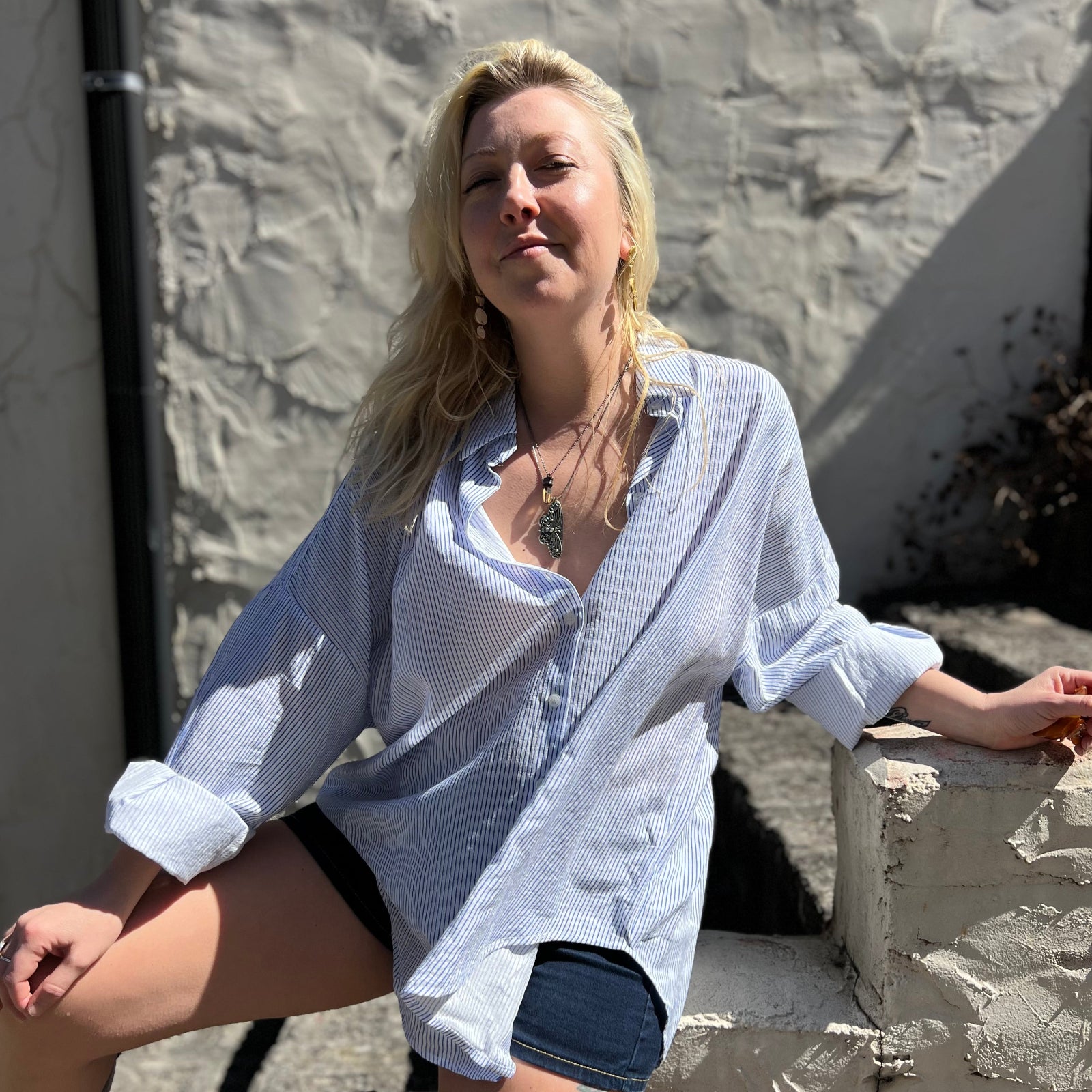 A woman wearing the Striped Button Down Long Sleeve Shirt Top.