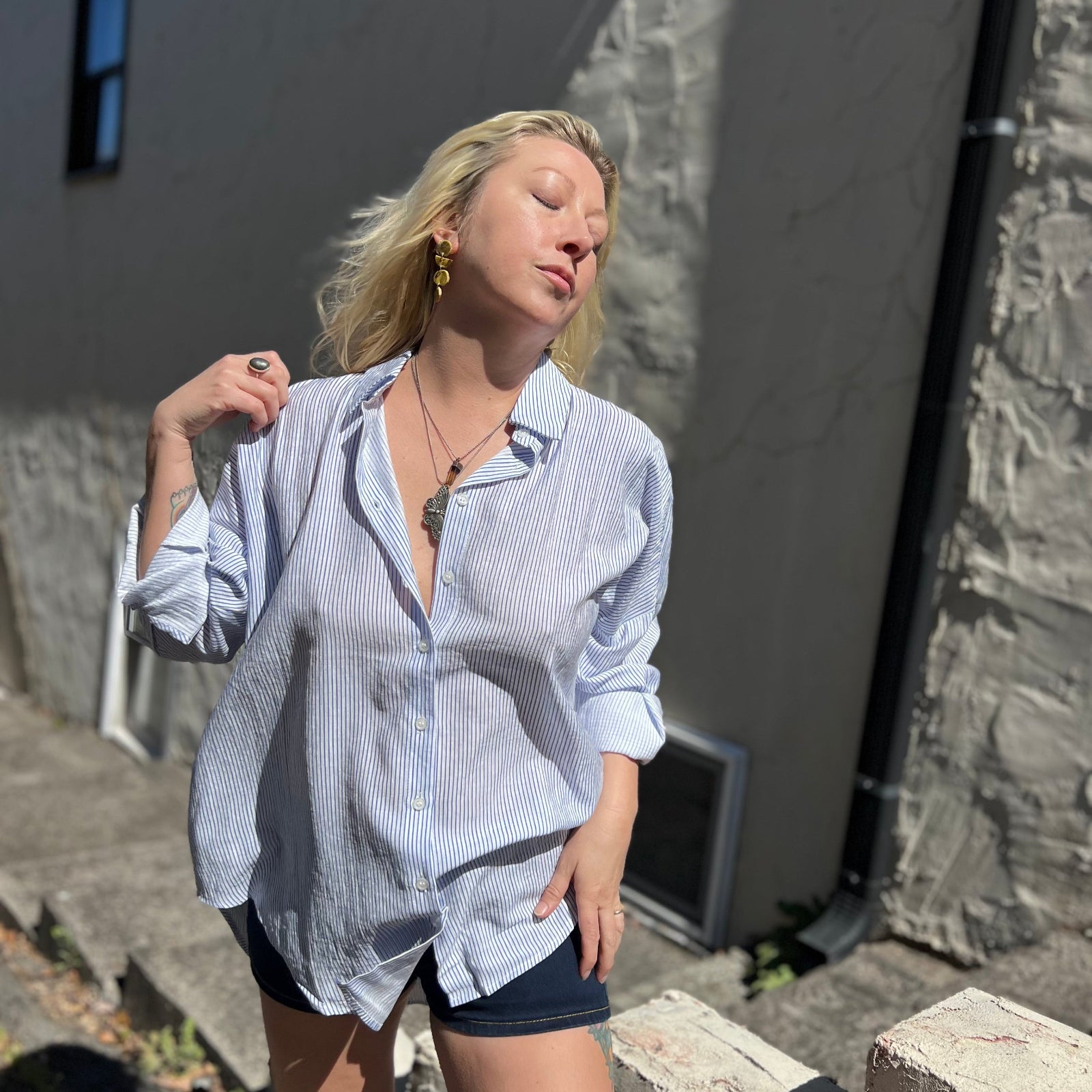 A woman wearing the Striped Button Down Long Sleeve Shirt Top.