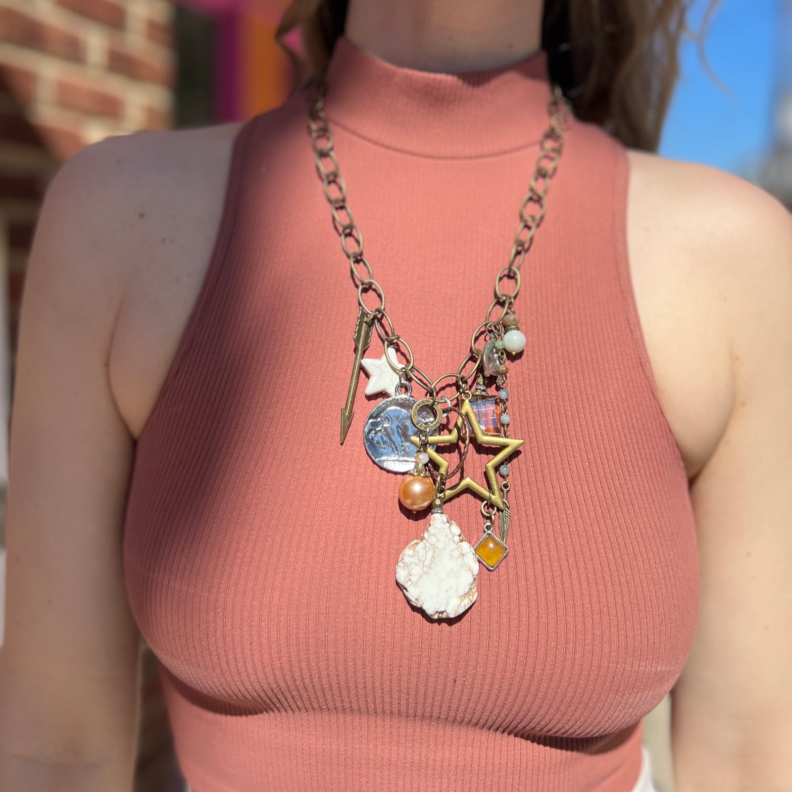 A woman wearing the Gypsy Junk Original Dutton 24" Necklace with a mauve tank.