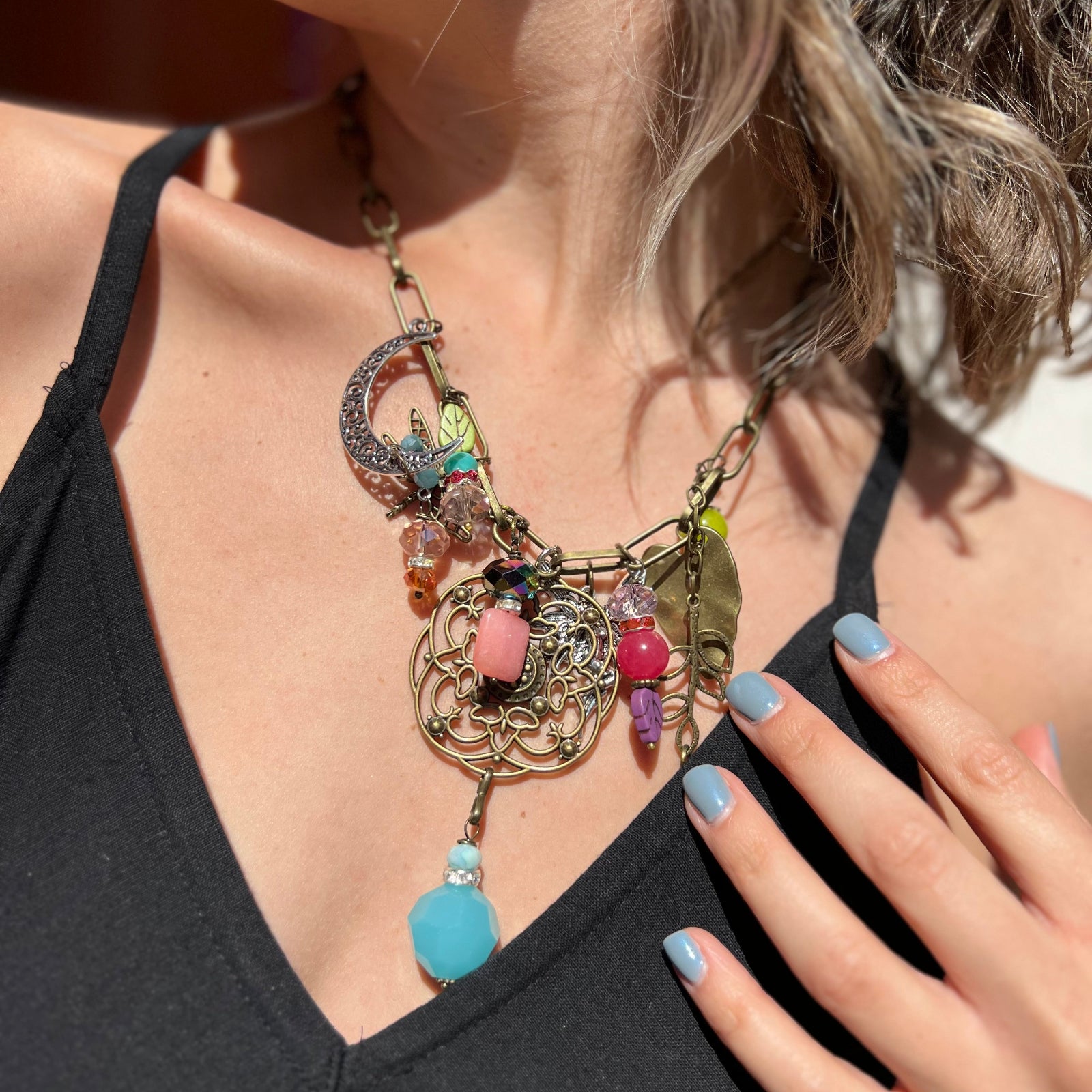 A woman wearing the Gypsy Junk Original Bright 24" Necklace with a black dress.