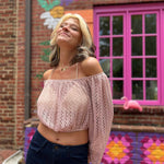 Model smiling in blush crochet crop top in front of The Boho Depot mural