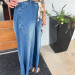 A woman wearing the dark wash Denim Drawstring Waist Band Wide Leg Pants with a cream crocheted top.