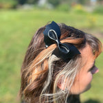 A woman wearing the Leather Bat Halloween Hair Clip.