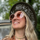 Someone wearing the ivory Bardot Seventies Round Sunglasses with a brown hat and brown kimono.