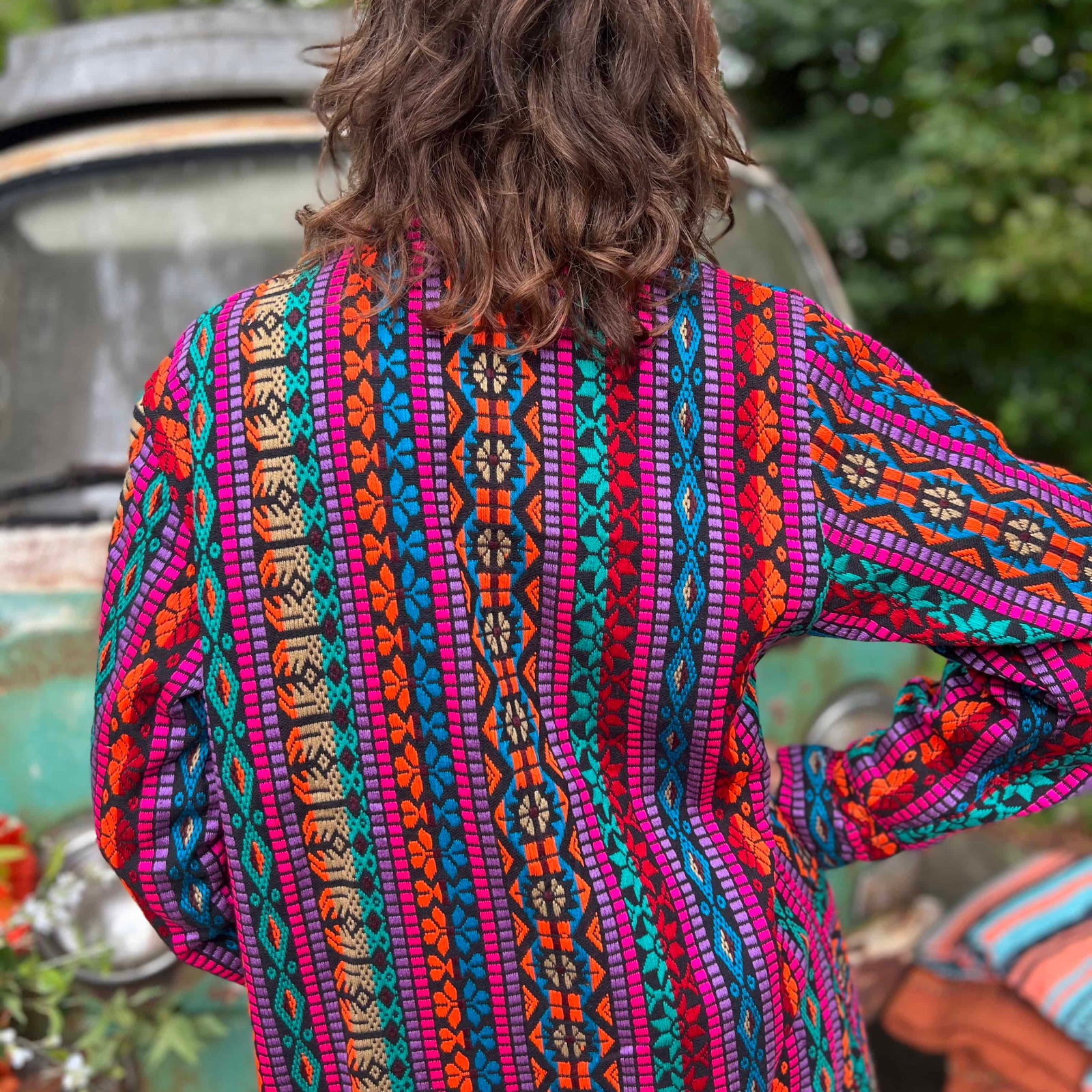 Back view of unisex hippie trench coat with woven cotton design