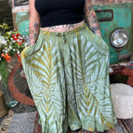 A woman wearing the green Hippie Bohemian Hand Dyed Palazzo Pants in front of a vintage Volkswagen bus.