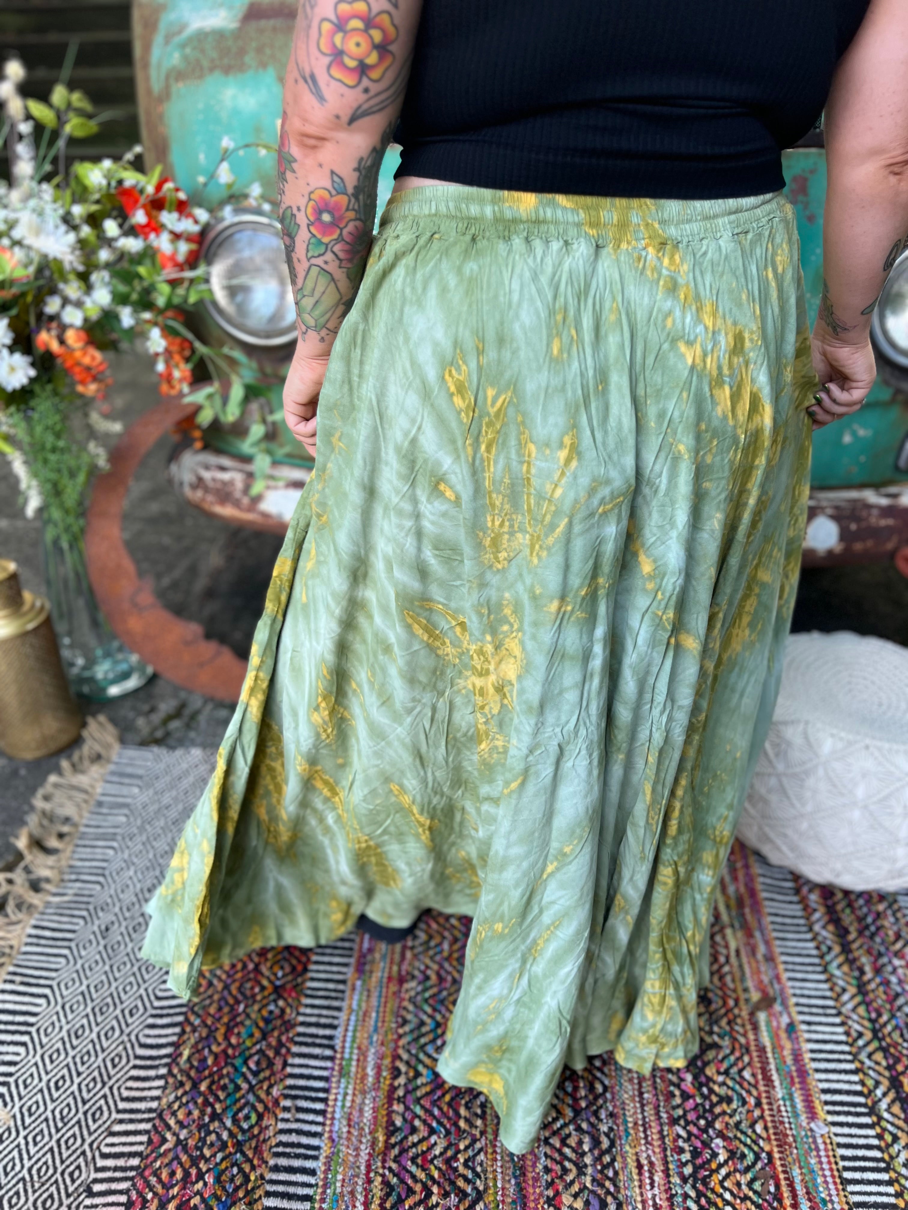 A woman wearing the green Hippie Bohemian Hand Dyed Palazzo Pants in front of a vintage Volkswagen bus.