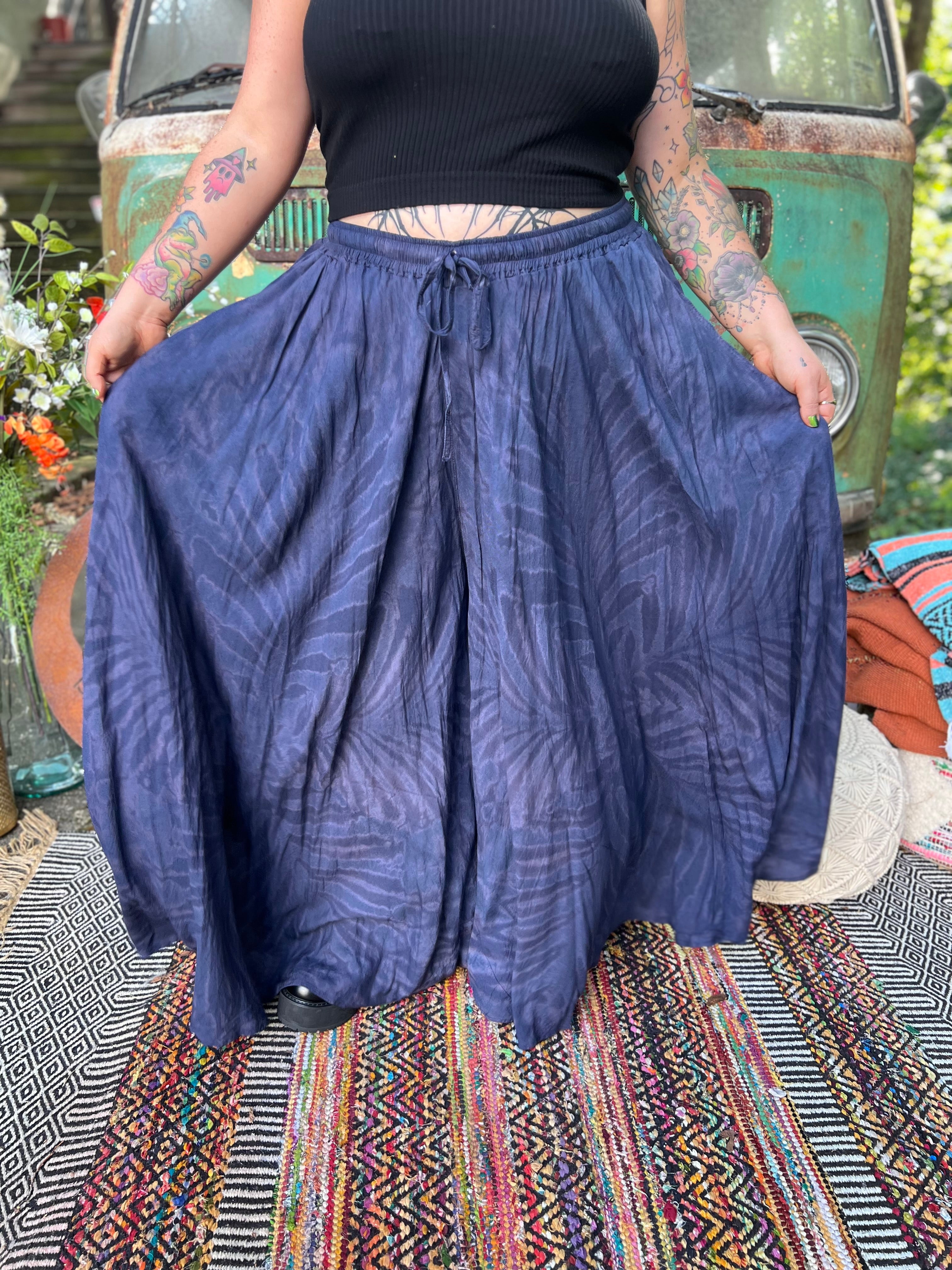 A woman wearing the navy Hippie Bohemian Hand Dyed Palazzo Pants in front of a vintage Volkswagen bus.