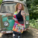 Someone wearing the Cotton Tie Dye Cat Crossbody Bag in front of the vintage Volkswagen bus.