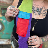 An up-close image of someone wearing the Cotton Tie Dye Cat Crossbody Bag in front of the vintage Volkswagen bus.