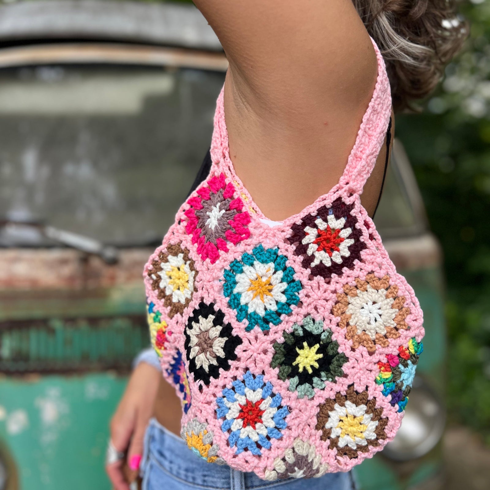 Someone wearing the pink Bohemian Handmade Crochet Bag.