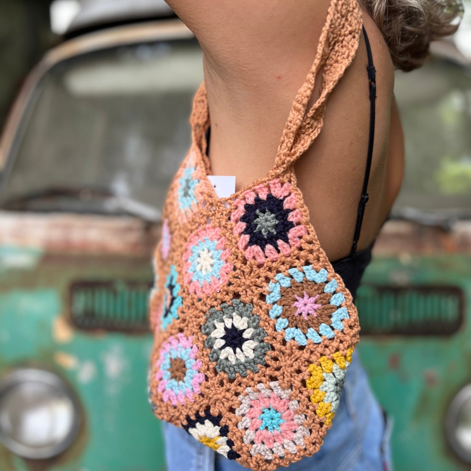 Someone wearing the khaki Bohemian Handmade Crochet Bag.