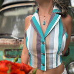 Someone wearing the turquoise multi Retro Striped Denim Halter Vest Top while holding red flowers.