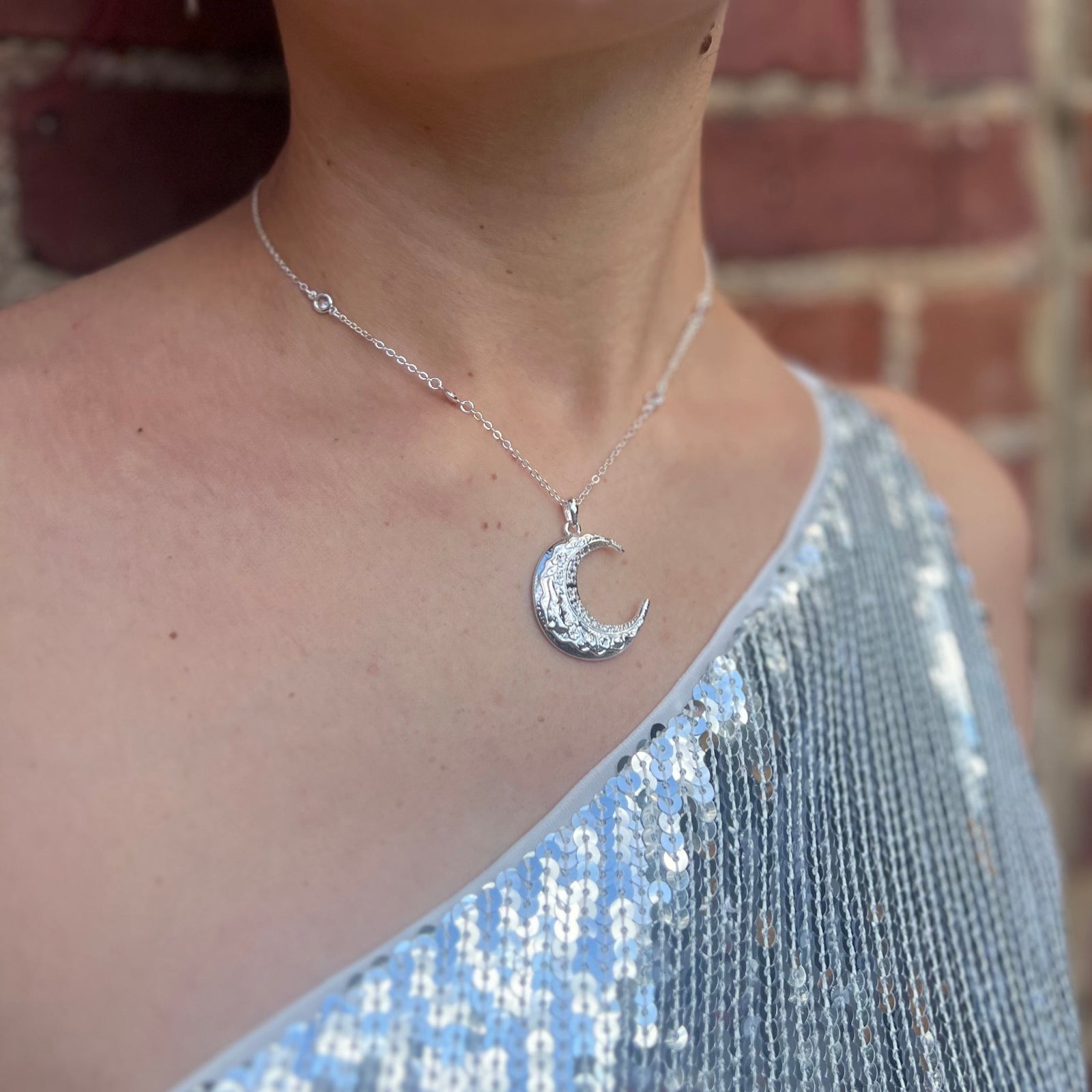 Someone wearing the The Hare Moon Silver Necklace.
