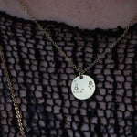 Someone wearing the Pisces 14k Gold Dipped Nickel-Free Zodiac Necklace with a black net top.