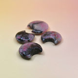 Four semi-precious stones with a marbled pattern on a gradient background