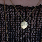 Someone wearing the Scorpio 14k Gold Dipped Nickel-Free Zodiac Necklace with a black net top.