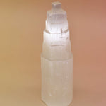 Crystal tower with 'Selenite' text on a beige background