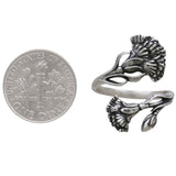 Silver floral ring next to a dime for size comparison on a white background