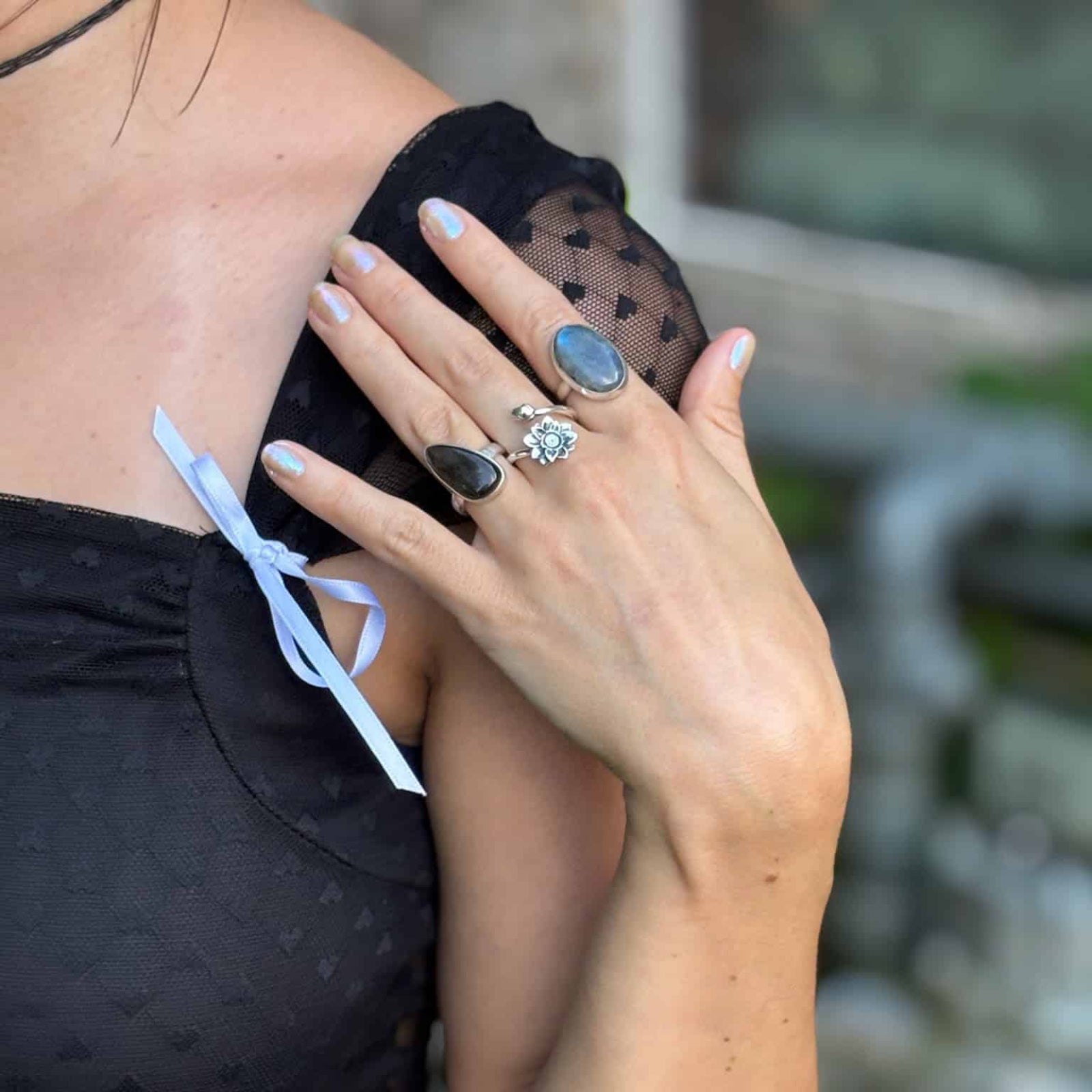 Person wearing a black top with a blurred background