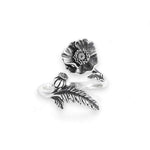 Silver ring with floral design on a white background