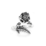 Silver ring with floral design on a white background