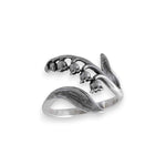 Silver ring with floral design on a white background