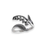 Silver ring with floral design on a white background