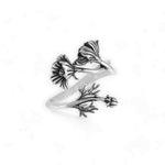Silver ring with floral design on a white background