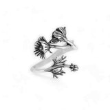Silver ring with floral design on a white background