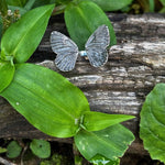 Butterfly Ring on a leaf with a natural background of green leaves and wood.
