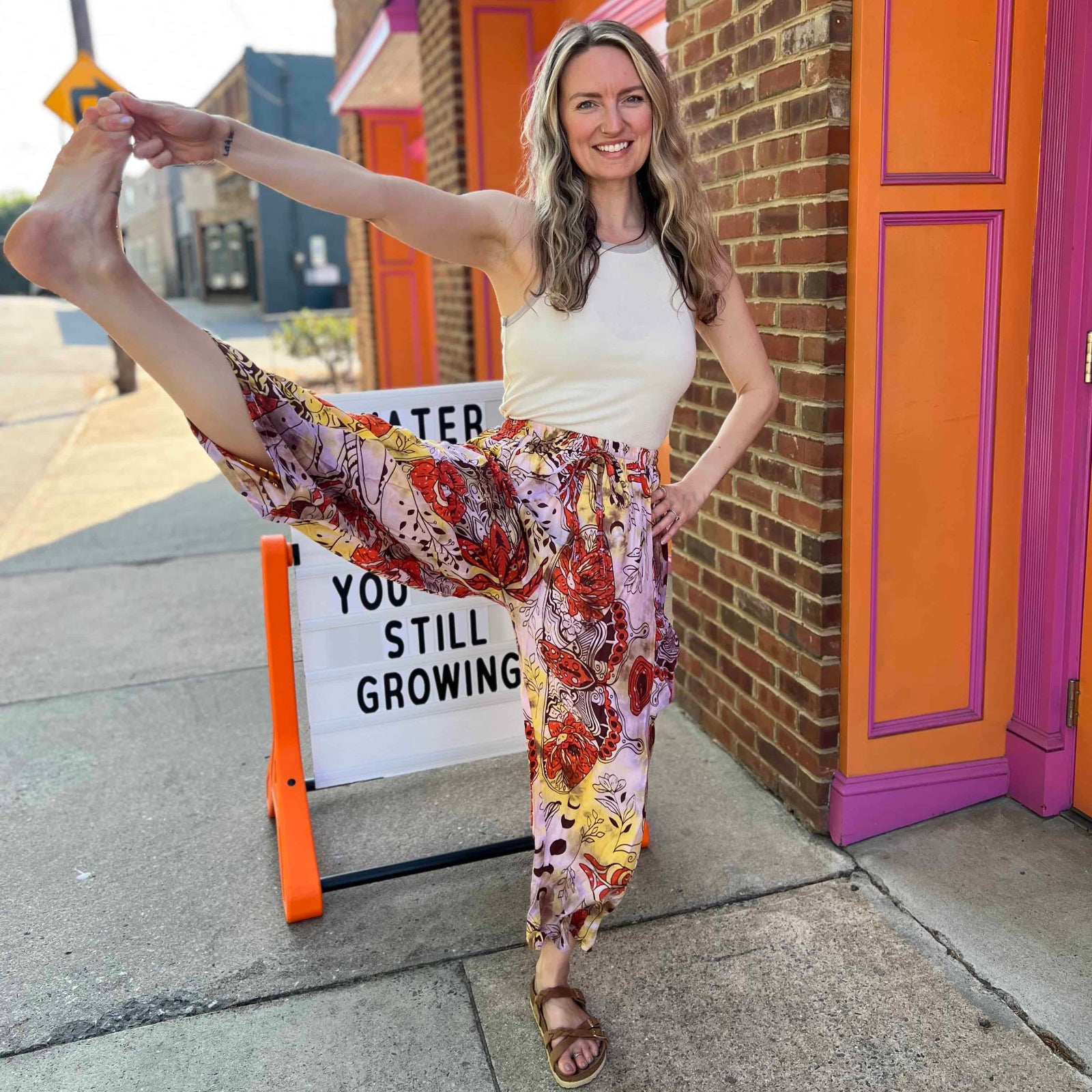 Boho wide-leg pants with colorful moon and nature print with model in yoga pose