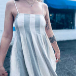 lightweight babydoll midi dress with spaghetti straps in front of shopping center