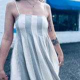 lightweight babydoll midi dress with spaghetti straps in front of shopping center