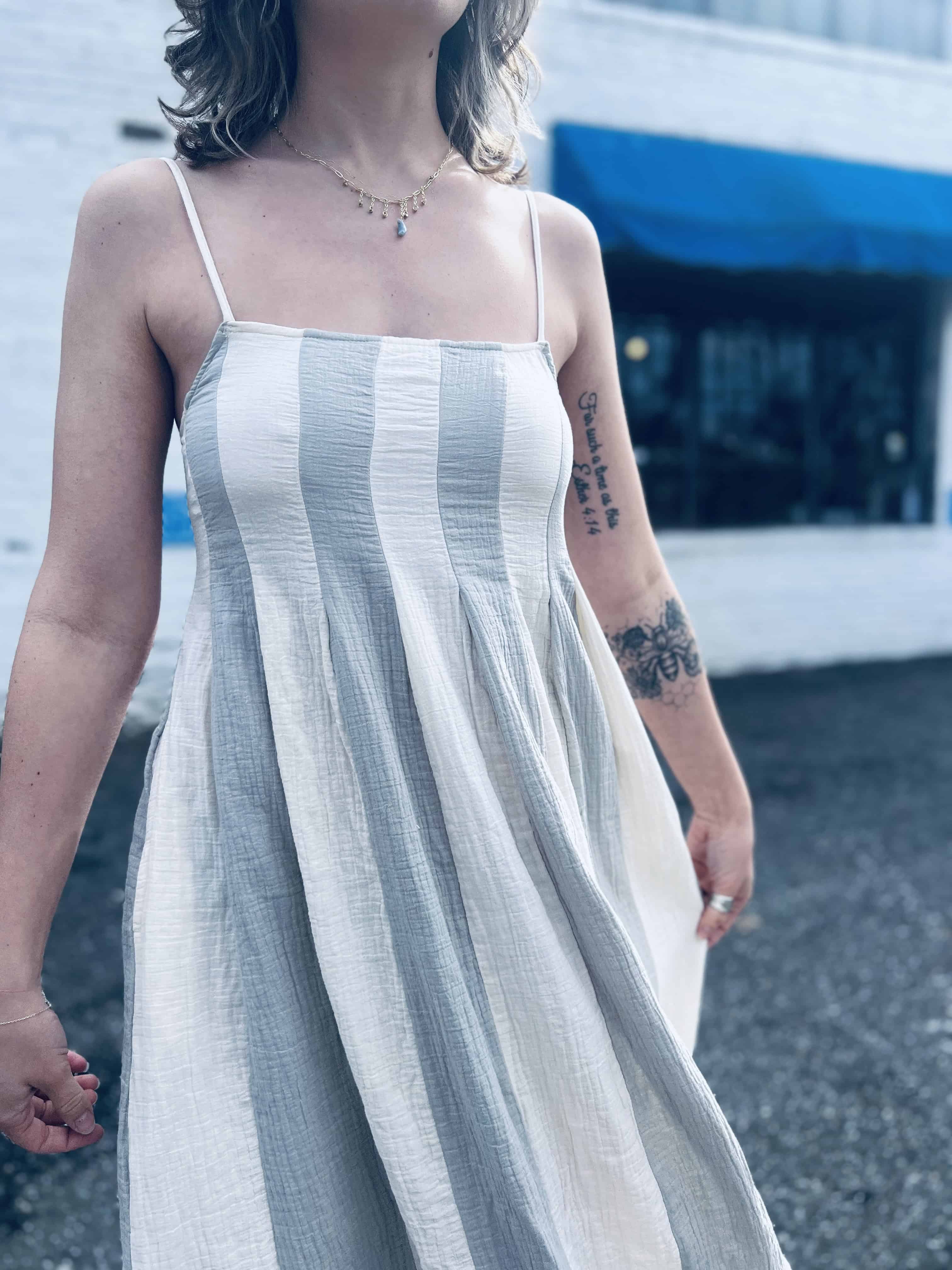 lightweight babydoll midi dress with spaghetti straps in front of shopping center
