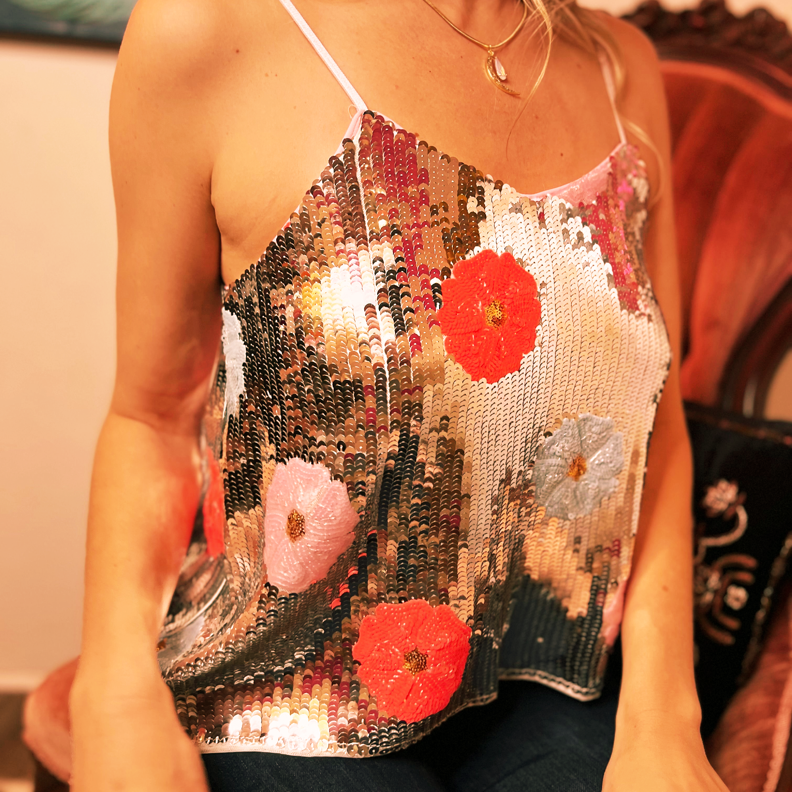 Someone wearing the Sequin Flower Embellished Crop Cami with jeans.