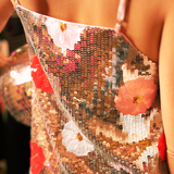 Someone wearing the Sequin Flower Embellished Crop Cami with jeans, showing off the back.