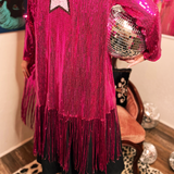 A woman wearing the Sequin Fringe Star Back Open Cardigan while holding a disco ball, and showing off the back.
