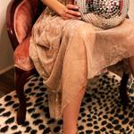 Someone wearing the Metallic Tulle Floral Maxi Skirt while sitting in a velvet chair and holding a disco ball.