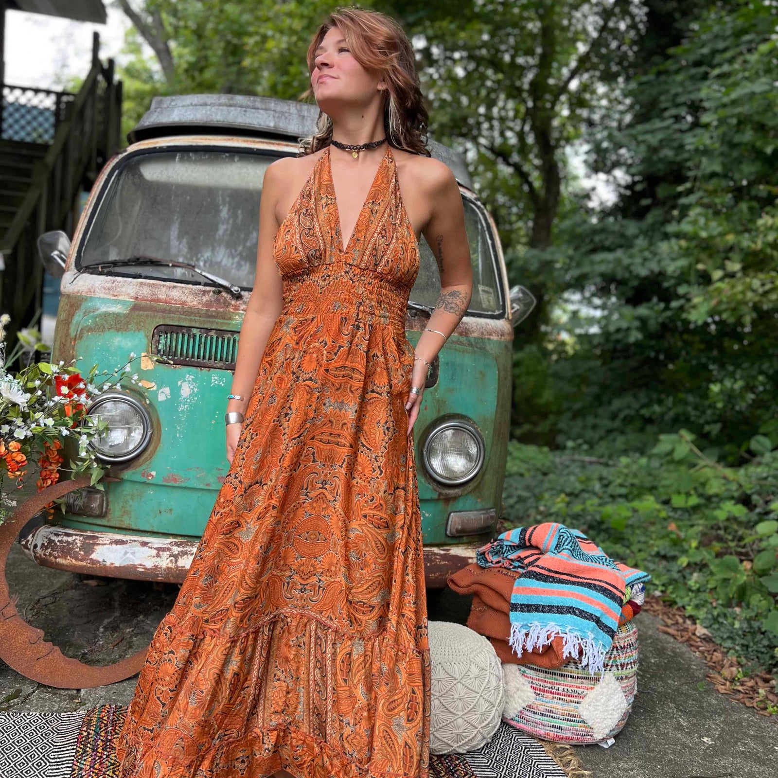 Woman twirling in flowy silk bohemian maxi dress
