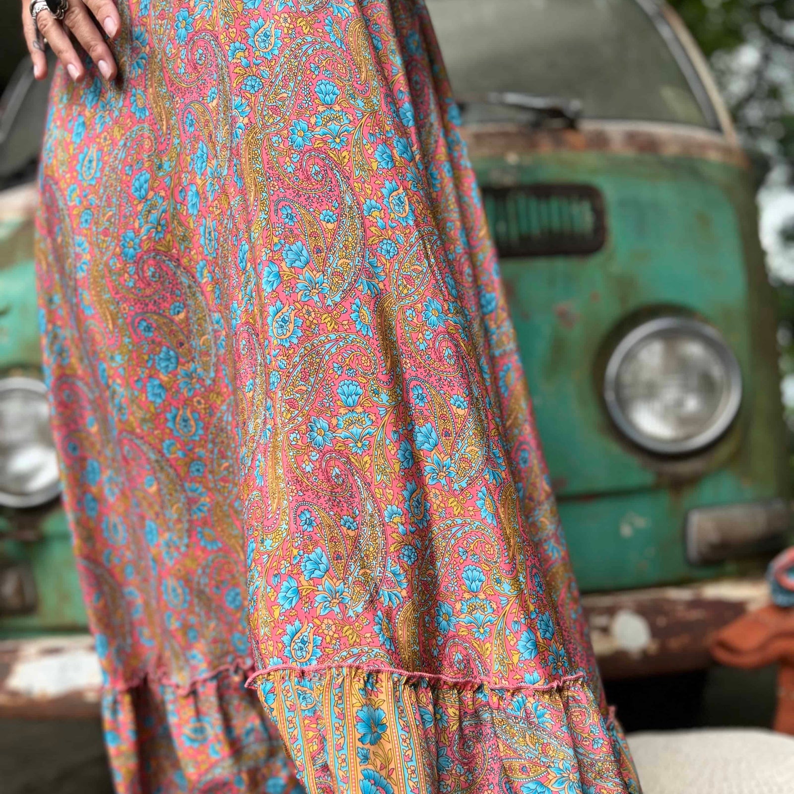 Woman twirling in flowy hippie boho maxi silk dress
