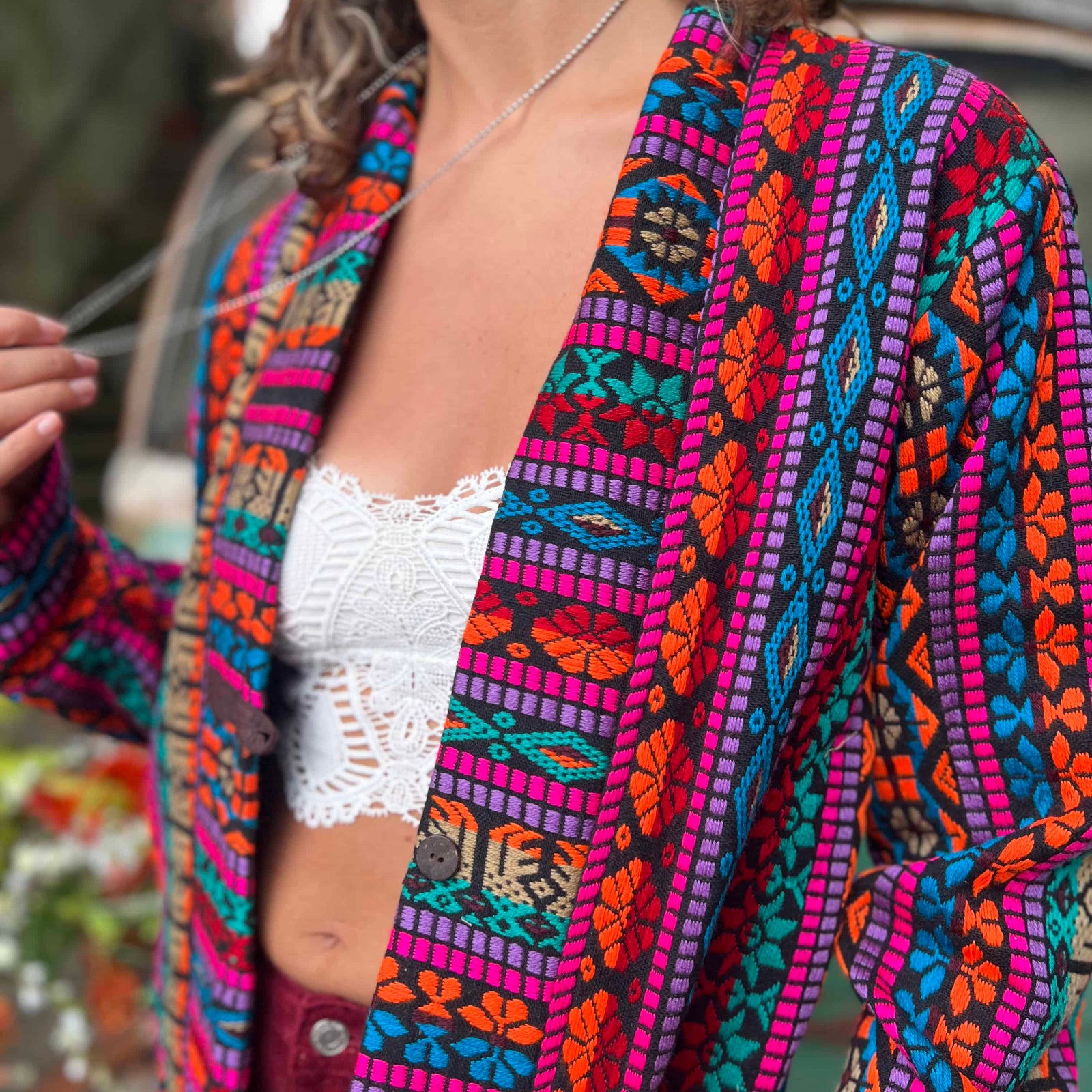 Close-up of woven cotton texture on boho trench coat