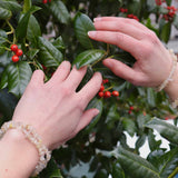 Golden Rutile Crystal Bracelet over holly bush