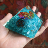 Close-up of blue orgone pyramid showing crystal details and copper spiral