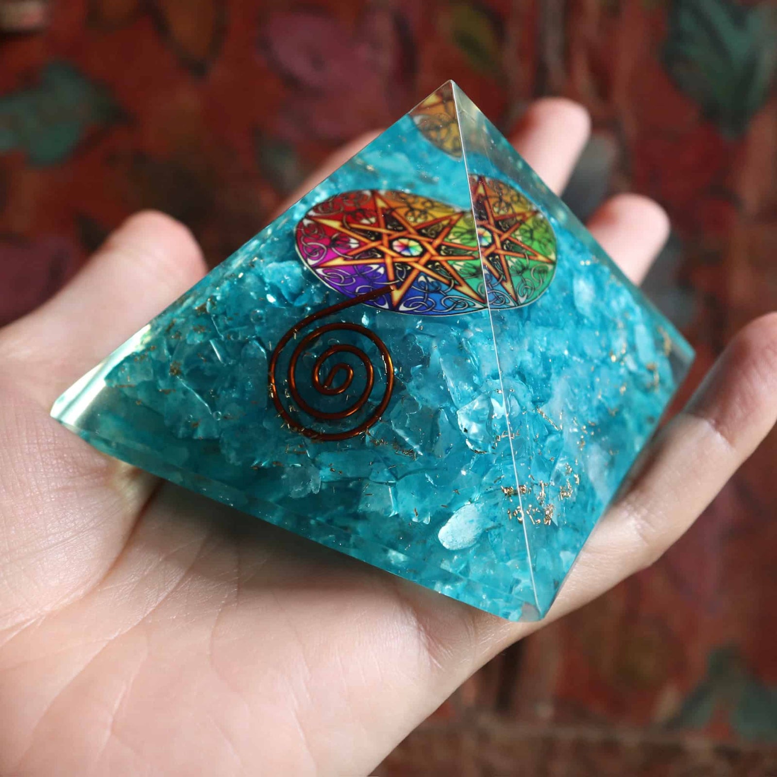 Close-up of blue orgone pyramid showing crystal details and copper spiral