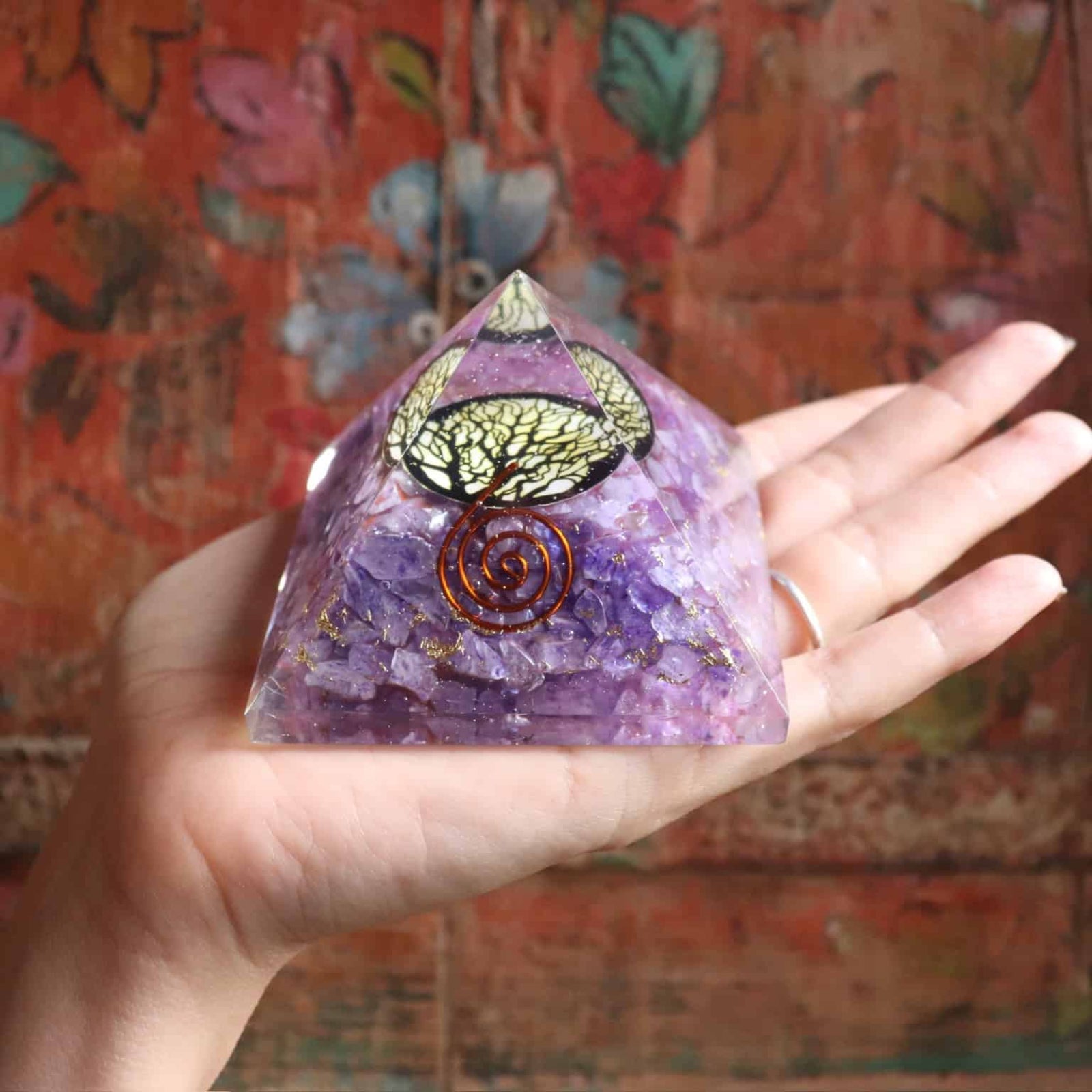 Side view of purple agate orgone pyramid with copper spiral